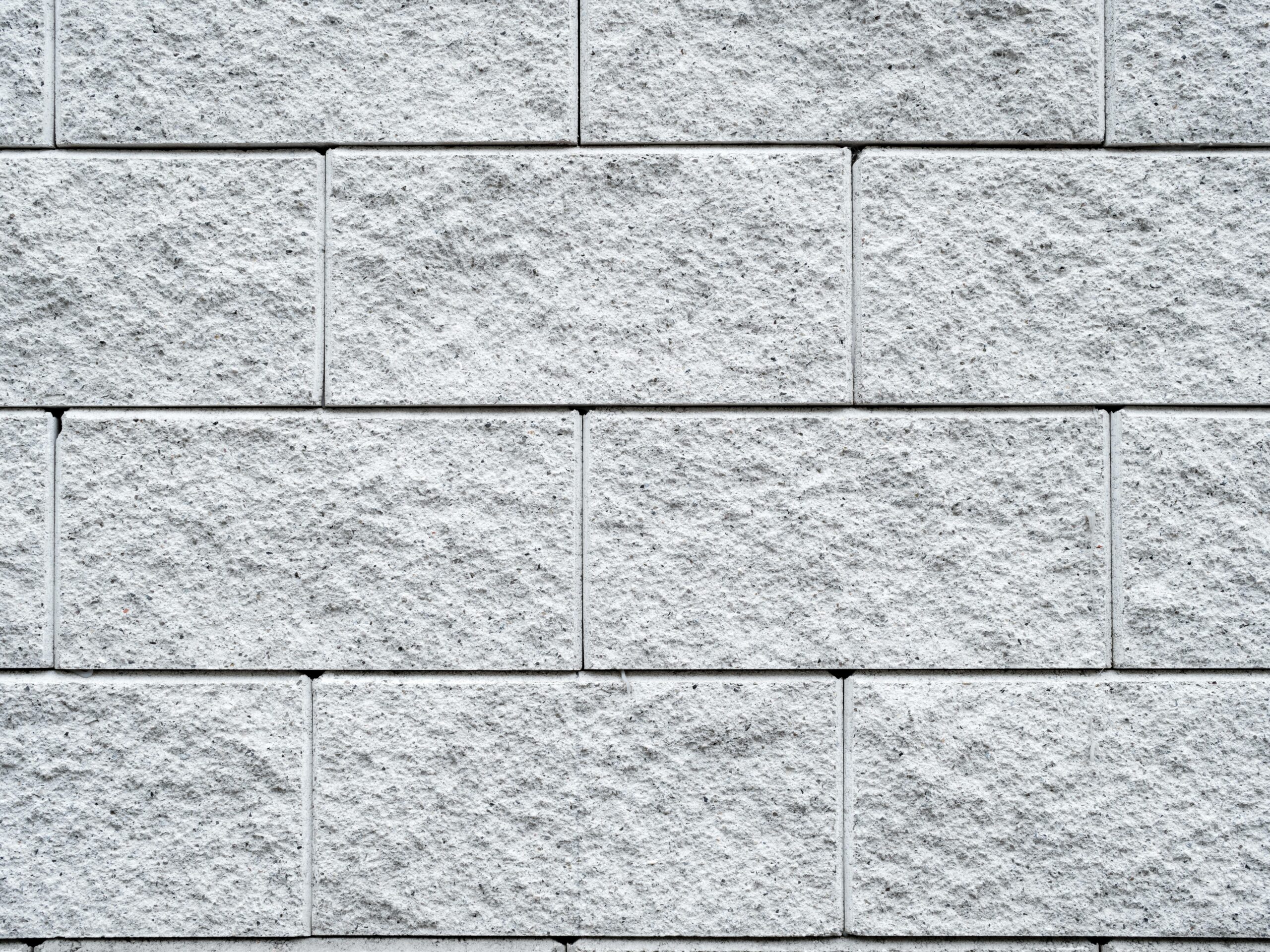 Detailed texture of a white brick wall, perfect for backgrounds and design projects.